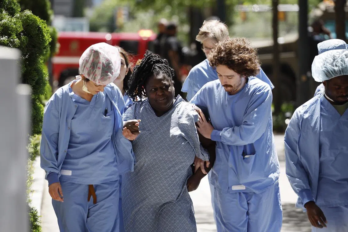 Medical workers and patients evacuate from a medical centre in the US city of Atlanta after a gunman opened fire.