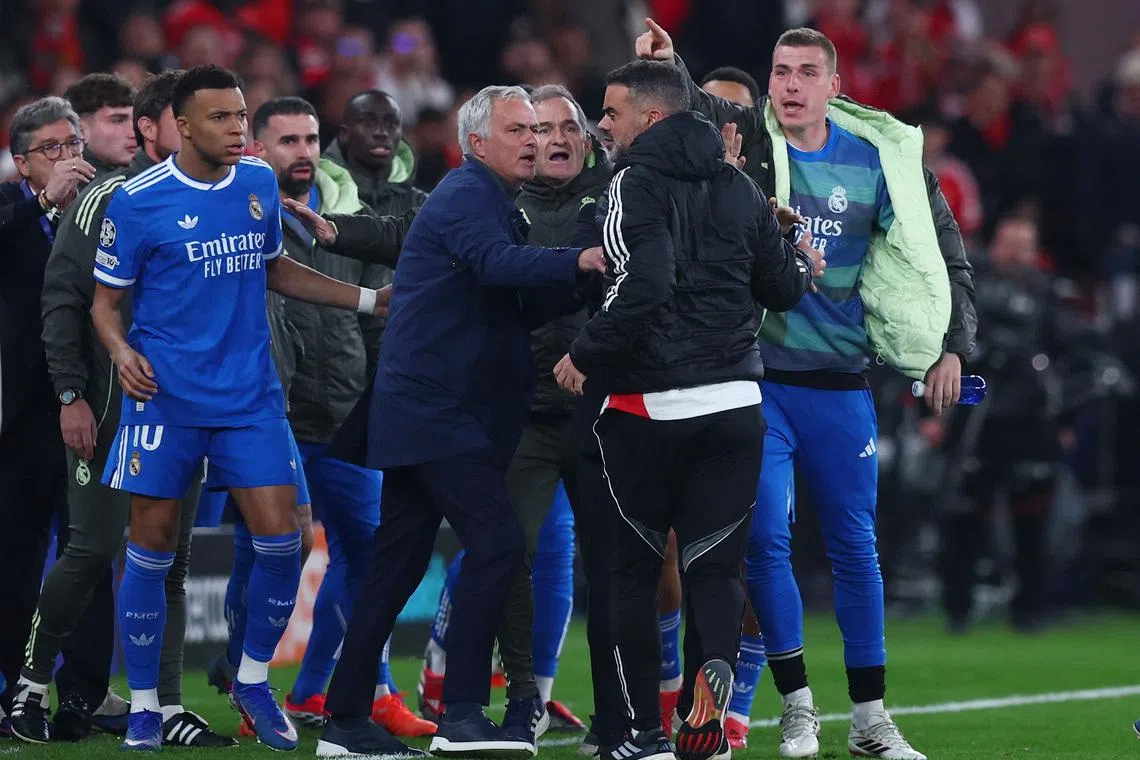 Soccer Football - UEFA Champions League - Play Off - First Leg - Benfica v Real Madrid - Estadio da Luz, Lisbon, Portugal - February 17, 2026 Real Madrid's Kylian Mbappe with Benfica coach Jose Mourinho as the match was stopped due to racist chants REUTERS/Pedro Nunes