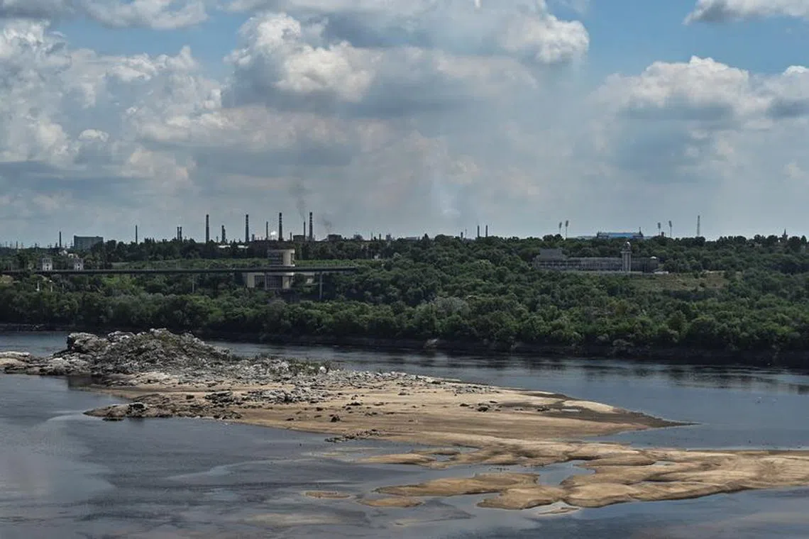 A view shows the city skyline and a rocky island in the Dnipro river which became visible again after water level sharply dropped following Kakhovka dam destruction, amid Russia's attack on Ukraine, in Zaporizhzhia, Ukraine June 25, 2023. REUTERS/Stringer/File photo