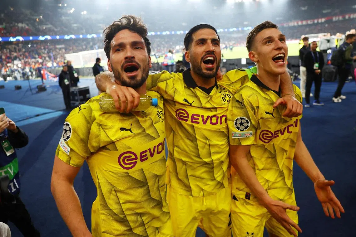 Borussia Dortmund's Mats Hummels, Emre Can and Nico Schlotterbeck celebrate after the match.