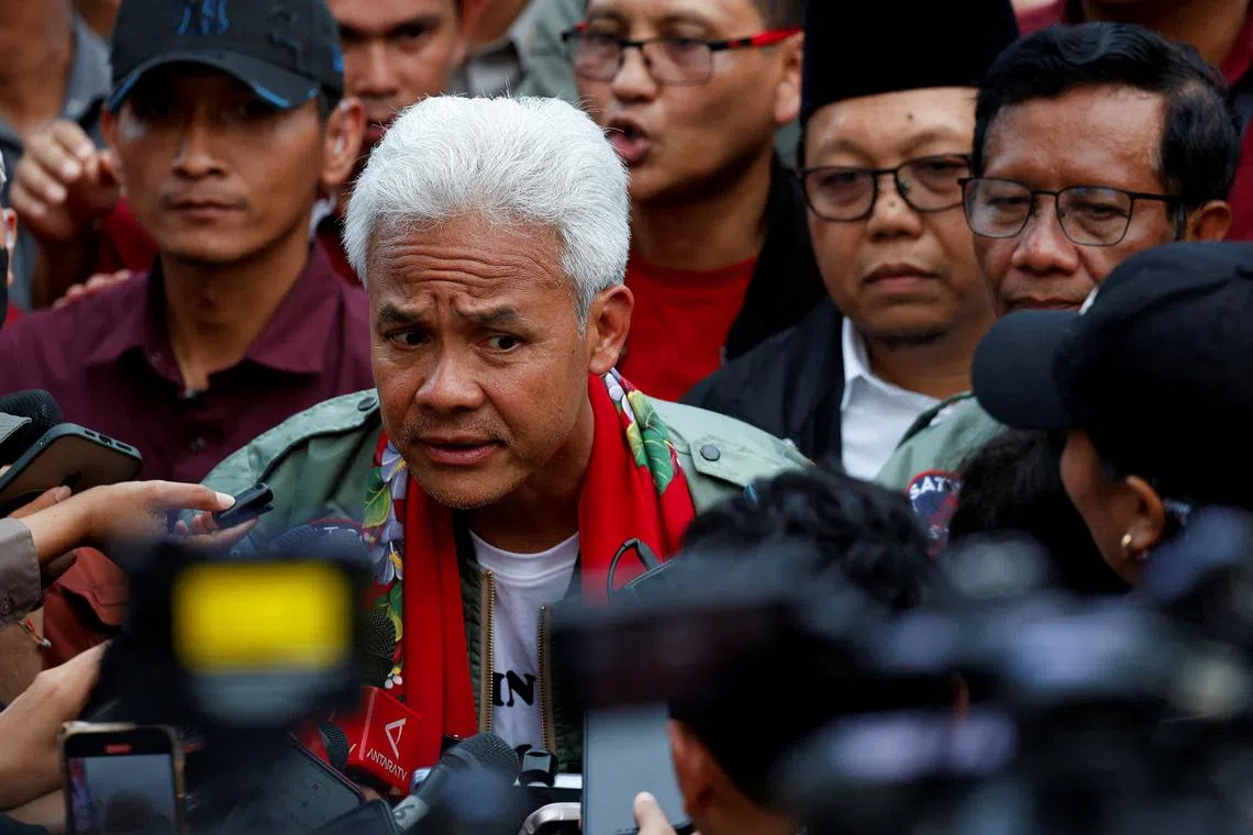 FILE PHOTO: Ganjar Pranowo, presidential candidate of the ruling Indonesian Democratic Party of Struggle (PDI-P), accompanied by his running mate Mahfud MD, speaks to journalists after their final campaign rally in Semarang, Central Java province, Indonesia, February 10, 2024. REUTERS/Willy Kurniawan/File Photo