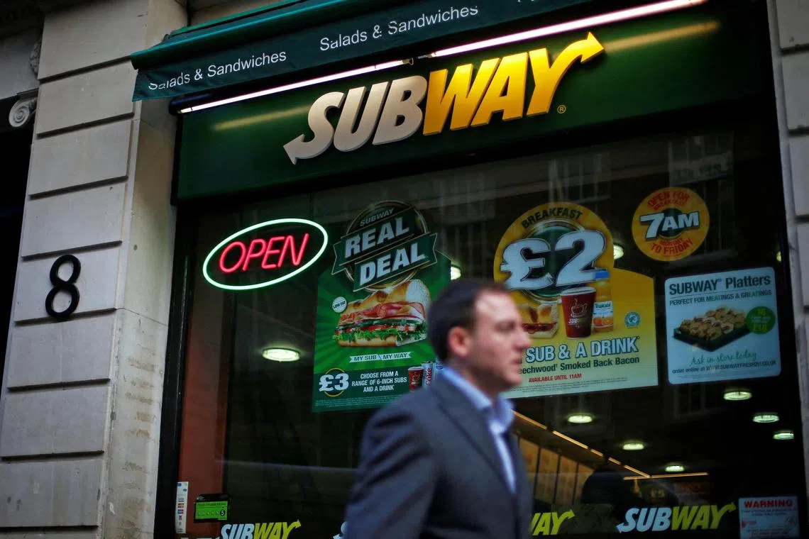 FILE PHOTO: A man walks past a Subway sandwich store in central London January 22, 2014. Subway, one of the largest fast-food chains in the world, plans to open over 1,200 new stores in the UK and Ireland by 2020, creating another 13,000 jobs, it said on Wednesday.
 REUTERS/Andrew Winning/File Photo