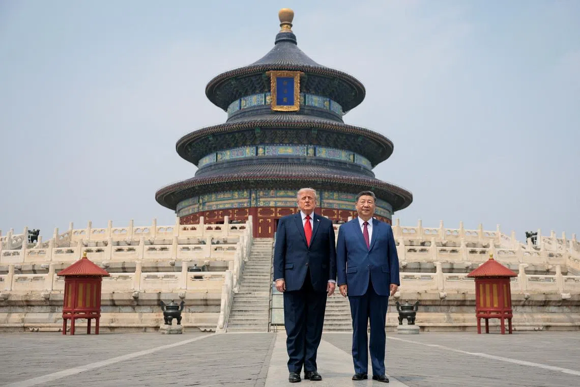 US President Donald Trump and Chinese President Xi Jinping standing together as they tour the Temple of Heaven in Beijing, China, on May 14.