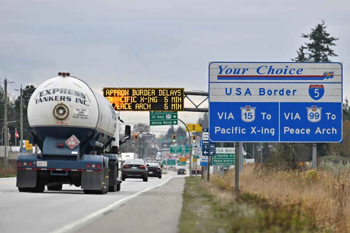 FILE PHOTO: Commercial trucks head towards the U.S. Customs and Border Protection (CBP) Pacific Highway Port of Entry from south Surrey, British Columbia, Canada, November 26, 2024.  REUTERS/Jennifer Gauthier/File Photo