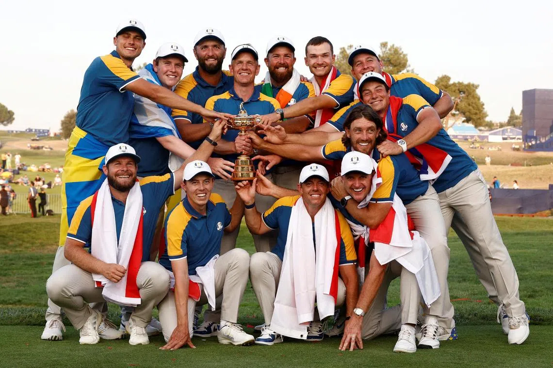 Team Europe captain Luke Donald and his team pose with the trophy as they celebrate after winning the 2023 Ryder Cup.