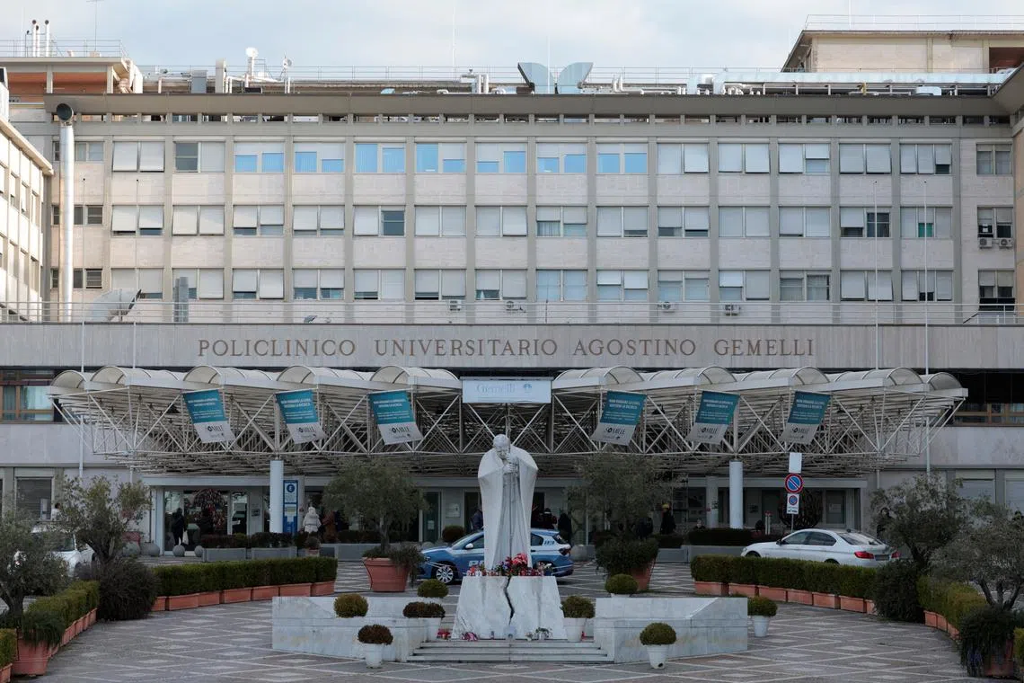 A view of the statue of late Pope John Paul II outside the Gemelli Hospital where Pope Francis is admitted to continue treatment for ongoing bronchitis, in Rome, Italy, February 17, 2025. REUTERS/Remo Casilli/File Photo