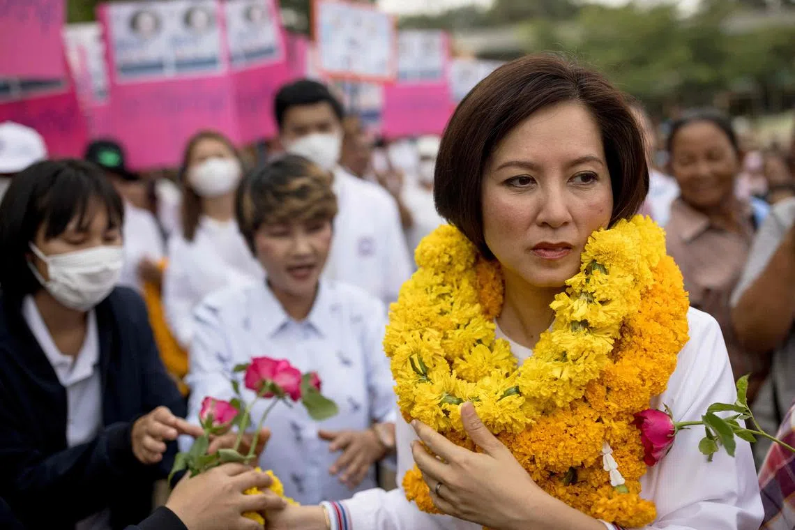 This picture taken on April 21, 2023 shows Treenuch Thienthong (R), education minister and local candidate in the upcoming general election, arriving for a Palang Pracharath Party campaign rally in the Thai province of Sa Kaeo. - Politics is a family affair for the Thienthong clan, one of Thailand's most enduring political dynasties, with five members running in next month's general election, for two different parties. (Photo by Jack TAYLOR / AFP) / To go with "Thailand-politics-election-dynasties", FOCUS by Thanaporn PROMYAMYAI and Alexis HONTANG