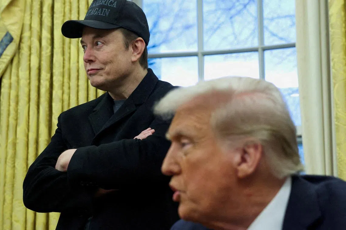 FILE PHOTO: Elon Musk listens to U.S. President Donald Trump speak in the Oval Office of the White House in Washington, D.C., U.S., February 11, 2025. REUTERS/Kevin Lamarque//File Photo
