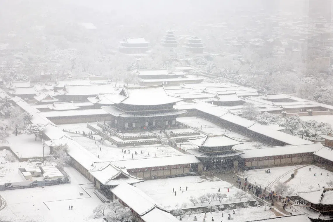 Gyeongbok Palace is blanketed with snow amid a heavy snowfall in downtown Seoul, on Nov 27, 2024. 