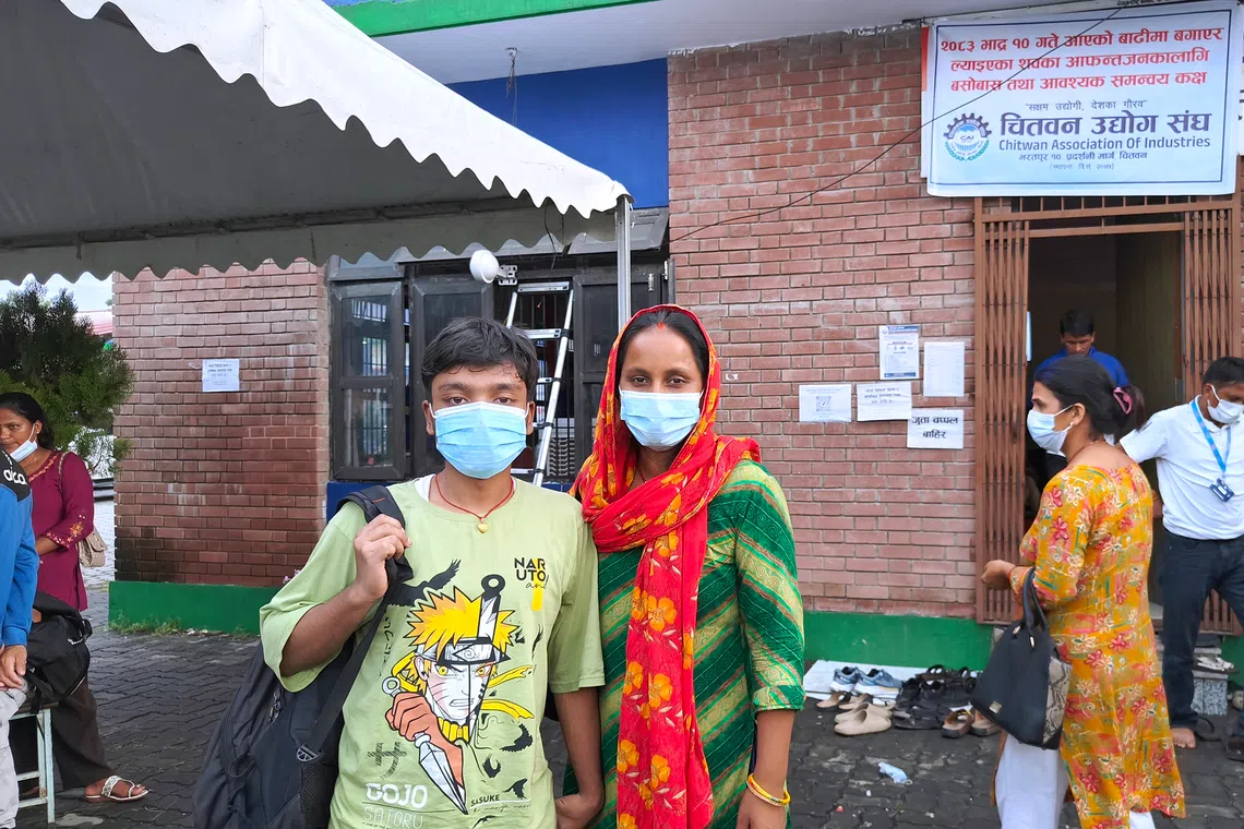 Biresh Kumar Sah (left) outside the temporary body identification camp in Bharatpur on Aug 30. His father and brother are missing since the flash flood.