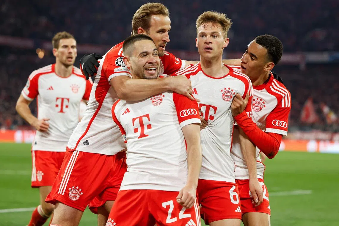 Bayern Munich midfielder Joshua Kimmich (second from right) celebrates scoring the winning goal with teammates Jamal Musiala (right), Raphael Guerreiro (centre) and Harry Kane.