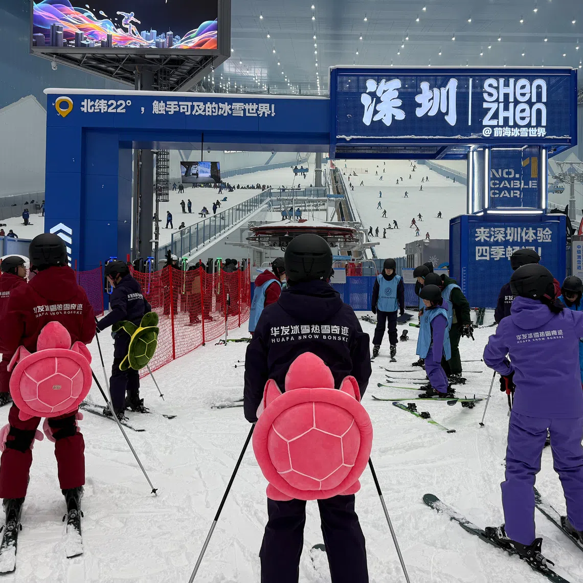 Wobbly first-timers donning turtle-shaped butt pads stood in line for beginner slopes at the Huafa Ice and Snow World  in Shenzhen on Oct 1.