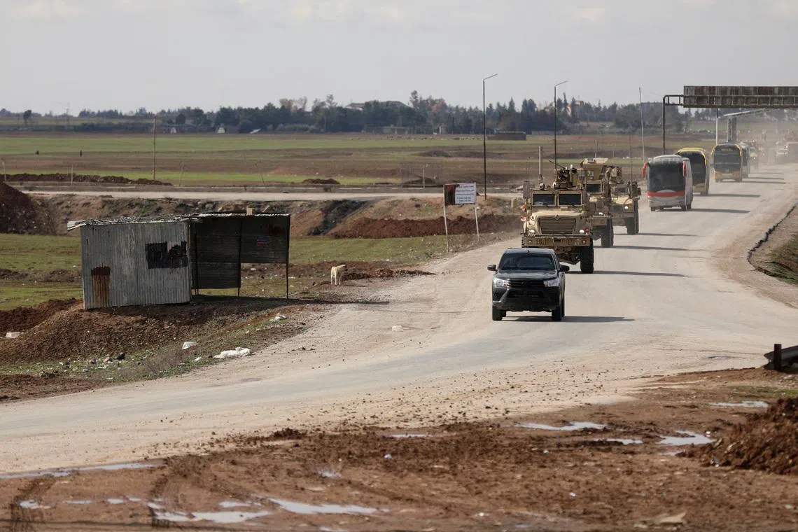 FILE PHOTO: U.S. military vehicles move ahead of buses transporting Islamic State detainees from Syria to Iraq, according to a security source from the Syrian Democratic Forces, in Qamishli, Syria, February 8, 2026. REUTERS/Orhan Qereman/File Photo