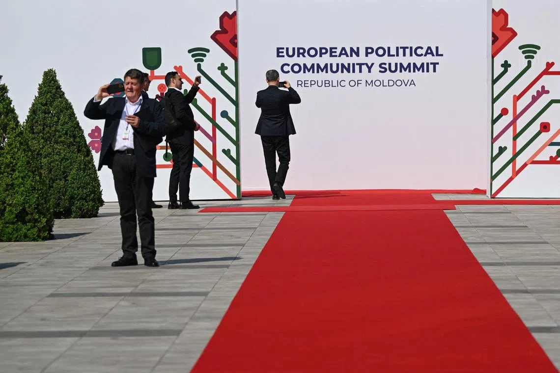 Officials take picture of the entrance of the "Mimi Castle" which will host the European Political Community (EPC) Summit, in Bulboaca on May 31, 2023. On June 1, 2023 Moldova will hold its first major summit of wider Europe, bringing together leaders of all 27 EU countries with 20 of the bloc's neighbours. President Maia Sandu told AFP in an interview on Mai 18, 2023 that Moldova was seeking EU membership "as soon as possible" as protection against any threat from Russia. (Photo by Daniel MIHAILESCU / AFP)