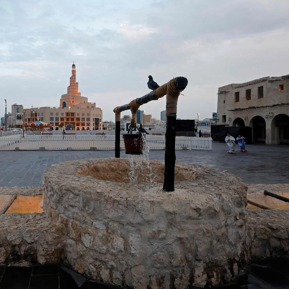 Pigeons sitting on a decorative water fountain in Qatar's capital, Doha, on March 4.