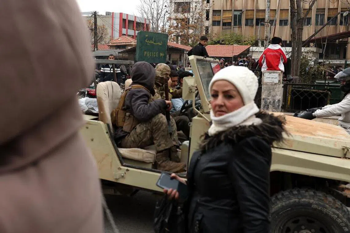 Anti government forces patrol the Syrian city of Salamiyah in the central Hama governorate, on Dec 7.