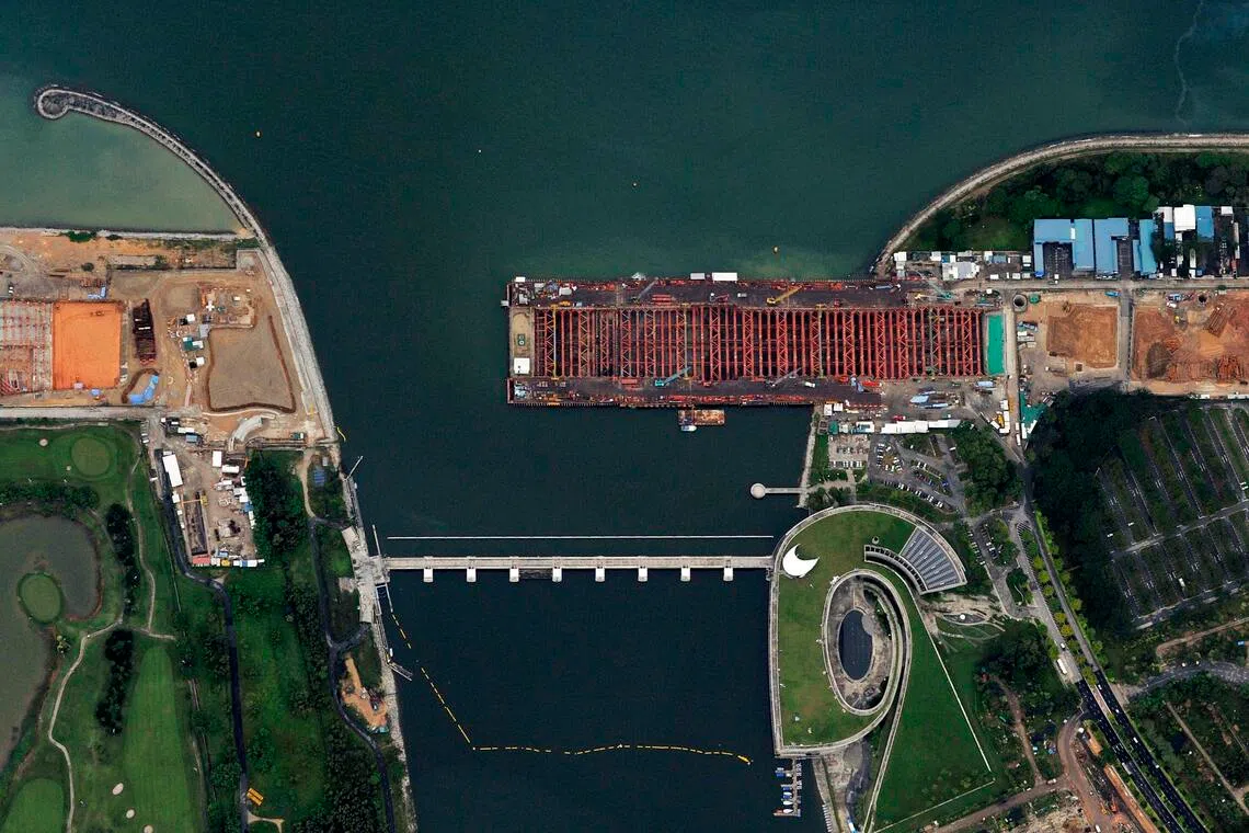Aerial photograph of the Marina Barrage (bottom) and the construction progress of the Marina Coastal Expressway (top). Photographed 14 July 2012.