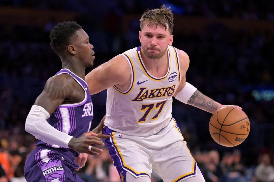 Sacramento Kings guard Dennis Schroder defending Los Angeles Lakers guard Luka Doncic during the Lakers' 125-101 NBA win at Crypto.com Arena on Dec 28, 2025.