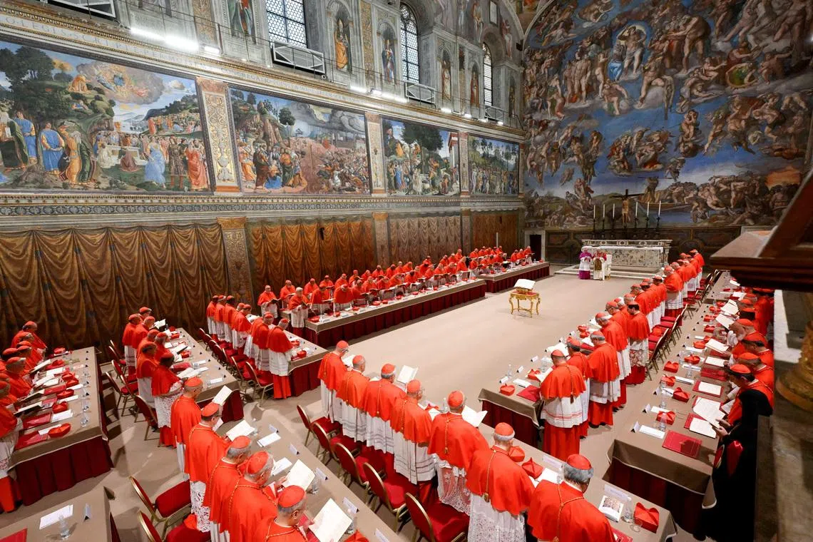 FILE PHOTO: Pope Leo XIV stands in the Sistine Chapel among cardinals after being elected, at the Vatican, May 8, 2025. Vatican Media/­Francesco Sforza/Handout via REUTERS/ File Photo