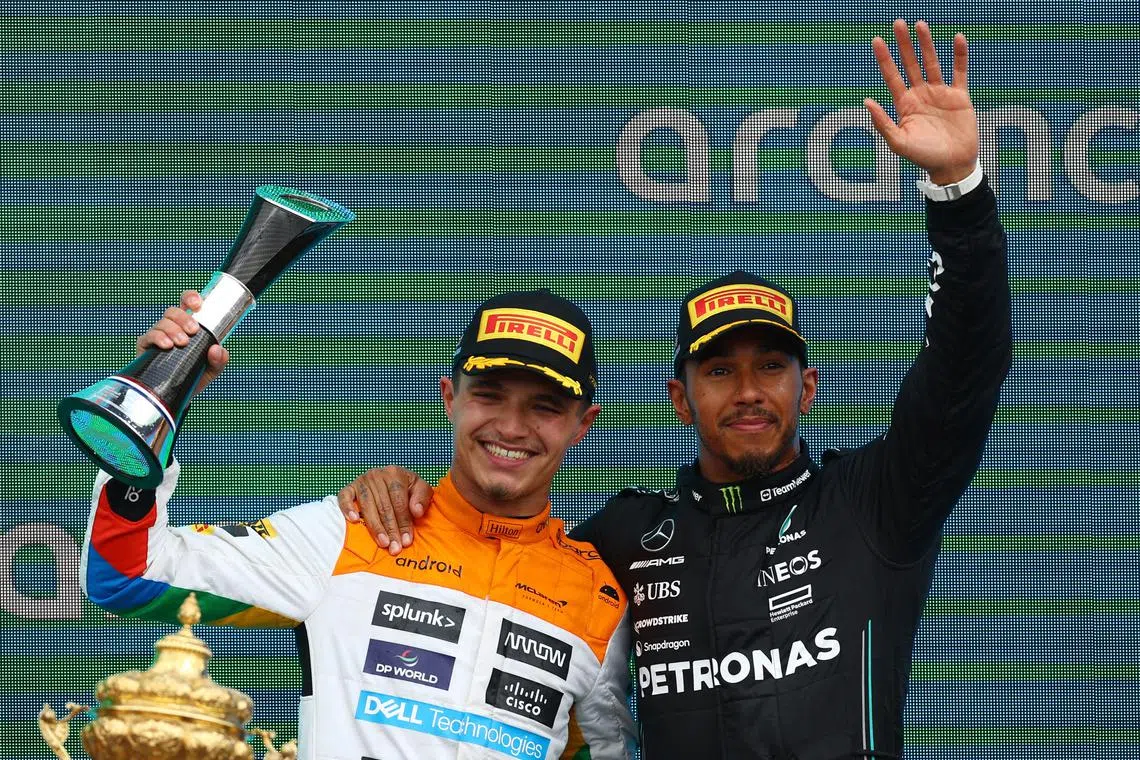 McLaren's Lando Norris (left) celebrates after finishing the race in second place with third placed Mercedes' Lewis Hamilton.