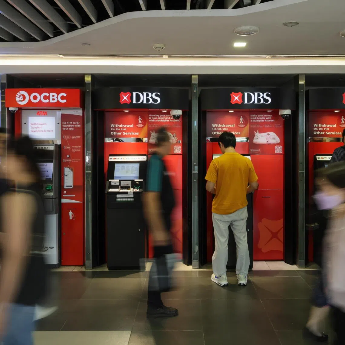 Generic photo of a man using the DBS ATM at Bugis Junction on Oct 2, 2025. 

Can use for stories on DBS, UOB, OCBC, finance business, bank, economy, convenience, Cash Machines (ATMs), deposit, credit , digital,