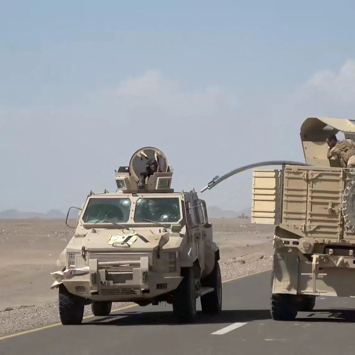 Military vehicles travel along a road during what Saudi-backed Yemeni government forces say was an advance against the Iran-backed Houthis, near Dhubab, Taiz Governorate, Yemen, in this still image taken from video released October 5, 2026.    Southern Giants Brigades/Handout via REUTERS