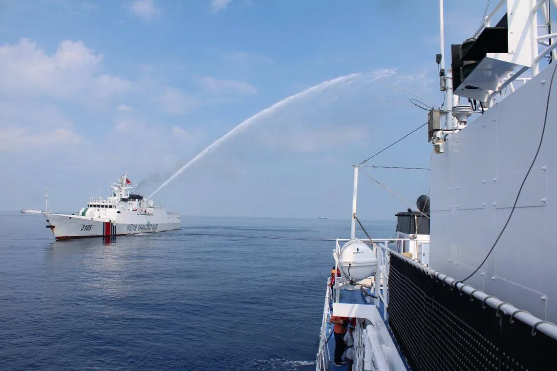 A Chinese Coast Guard ship firing a water cannon on a Philippine Coast Guard vessel at the vicinity of Scarborough Shoal, on April 30.