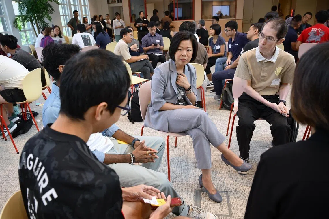 Senior Minister of State for Home Affairs Sim Ann speaking with attendess at the "Holding the Centre: Navigating Online Polarisation" forum on June 13.
