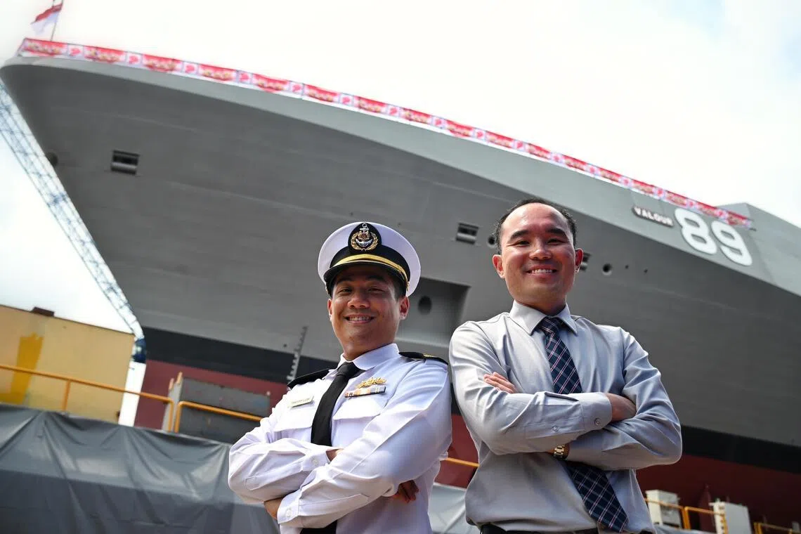 Lieutenant-Colonel Timothy Low (left) with DSTA senior programme manager Foo Ce Yang in front of Valour.
