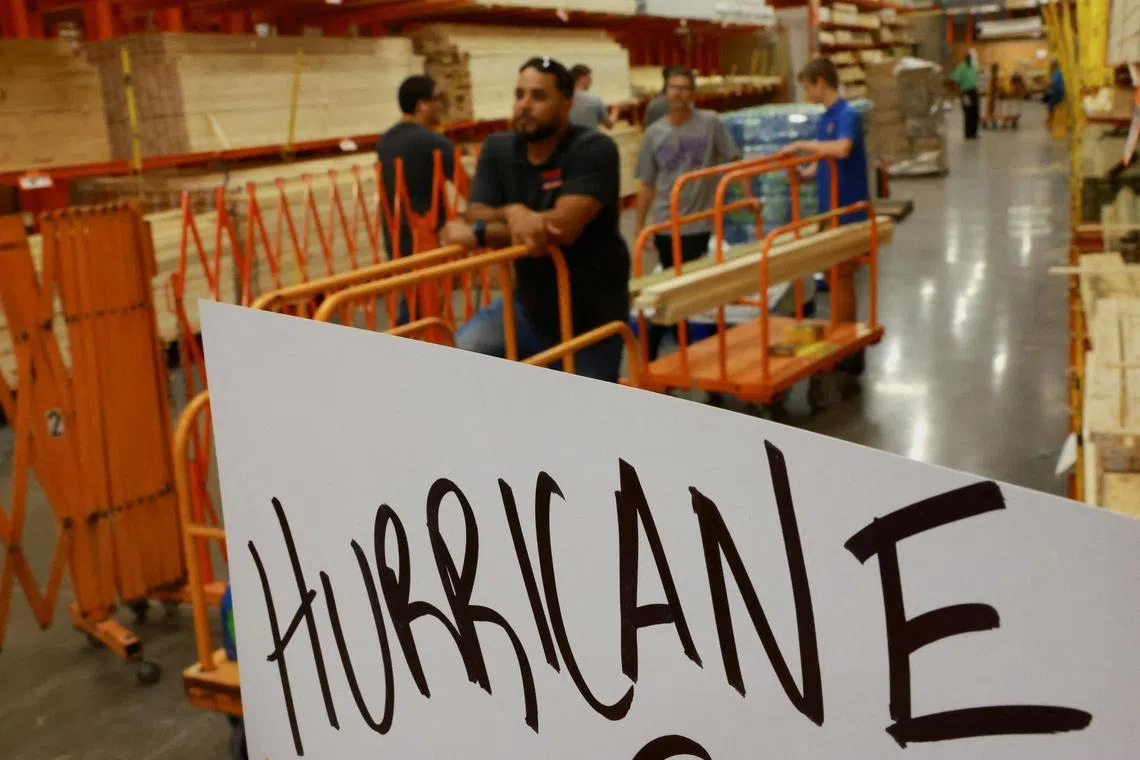 People line up to buy wood to protect their assets before Hurricane Milton tears across the state in Orlando, Florida, US on Oct 8, 2024. 