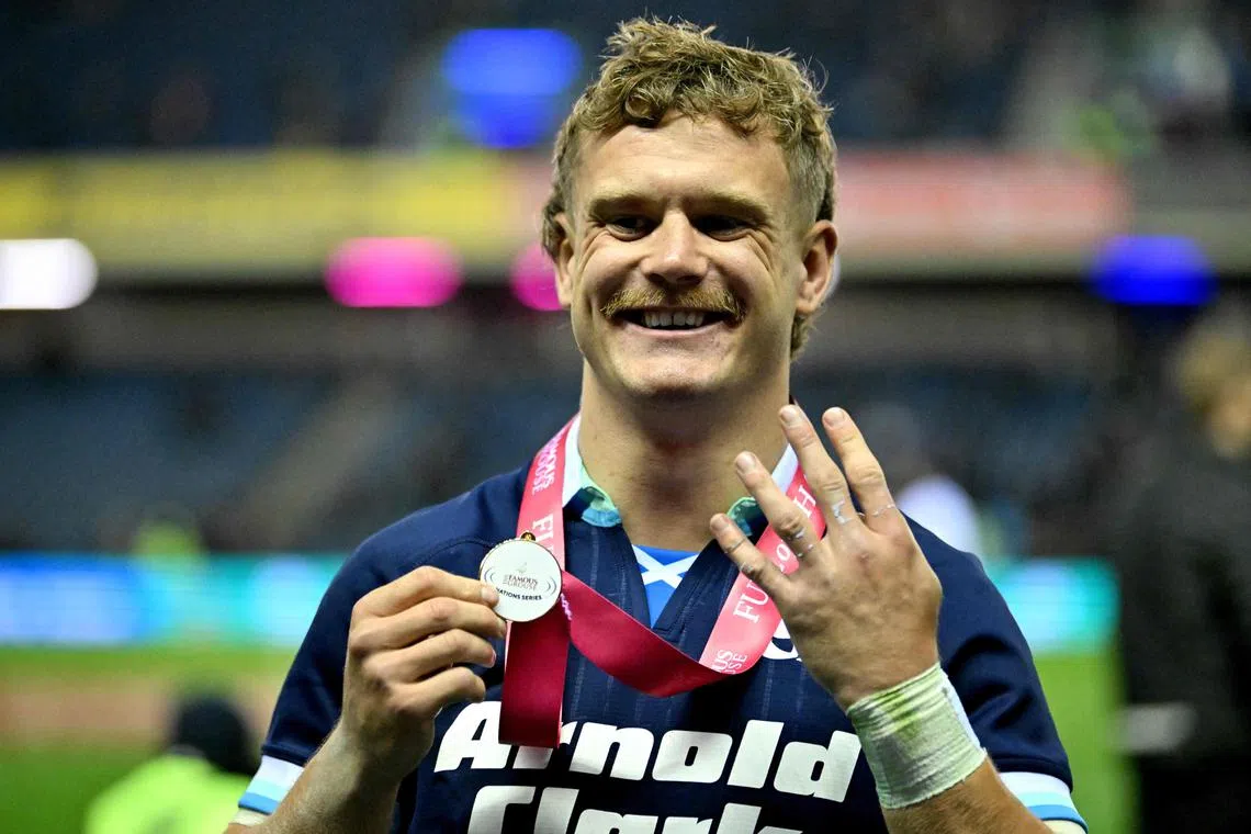 Scotland's wing Darcy Graham celebrates with his man of the match medal following the win over Fiji.
