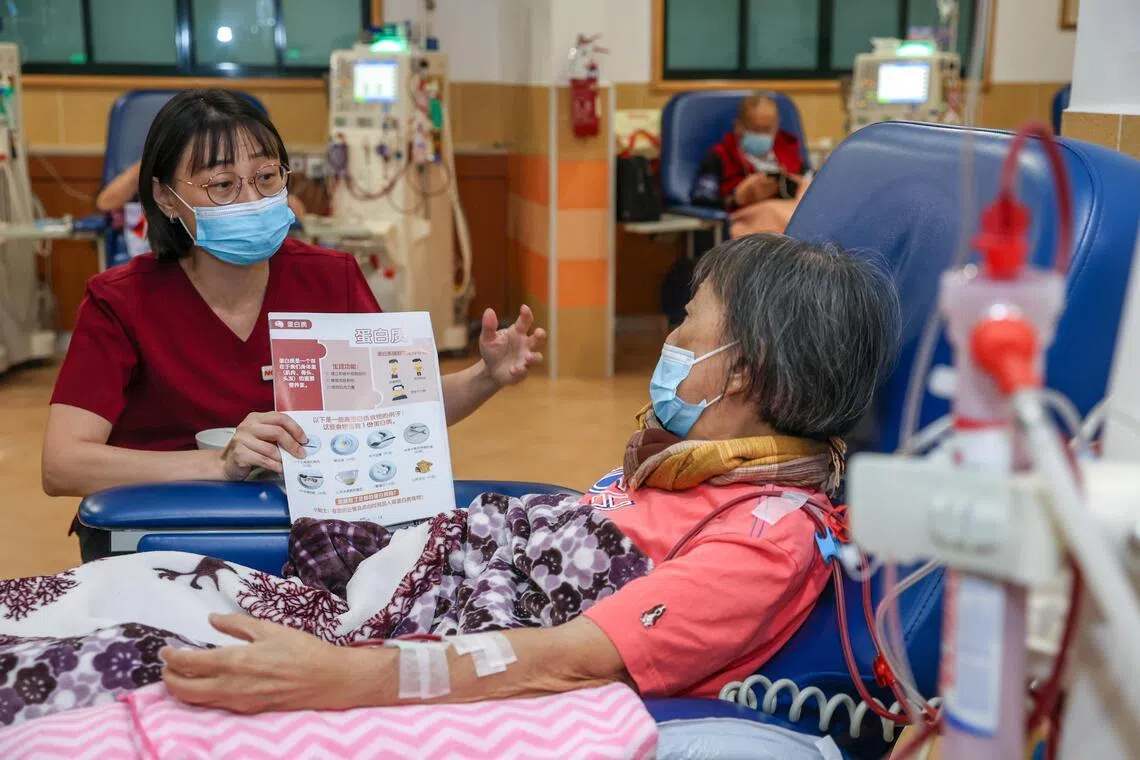NKF principal dietitian Yee Chooi Fong explaining protein requirements to Neo Ah Lek at NKF’s 633 Ang Mo Kio Dialysis Centre on June 24.