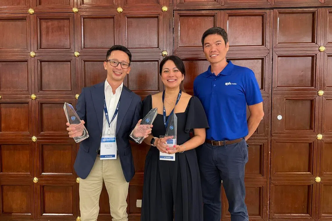 (From left) The Straits Times' assistant audience growth editor Stanley Huang, SPH Media’s Studio+65 head Michell Tan and SPH Media deputy chief executive officer Kuek Yu Chuang celebrating ST's double win.