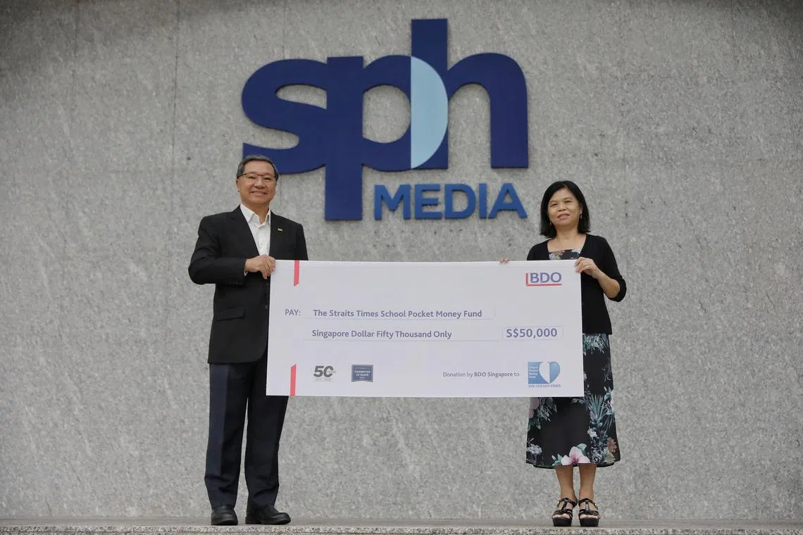 BDO Singapore managing partner Frankie Chia (left) presented the cheque to STSPMF general manager Tan Bee Heong at the SPH News Centre.