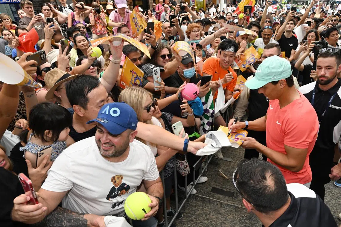 Rafael Nadal signs autographs for fans at the Queen Street Mall in Brisbane, Australia on Dec 29. The Spanish star will be playing in the Brisbane International after taking a long break from tennis due to an injury. 