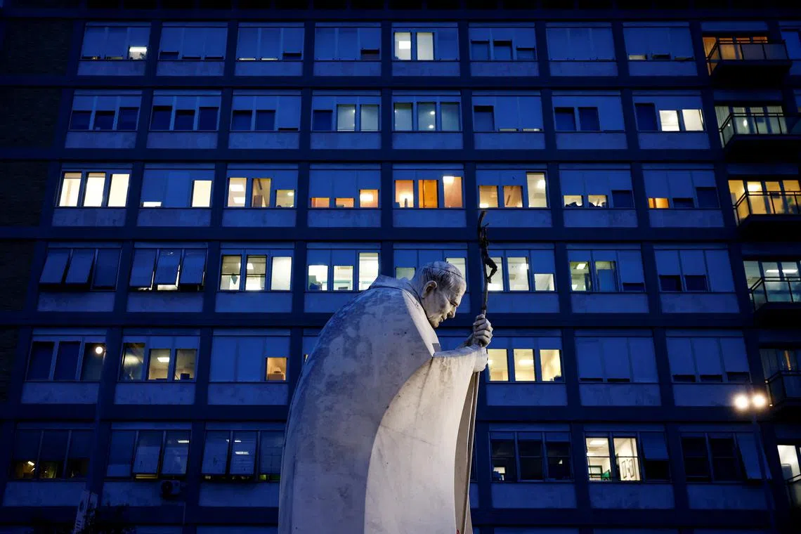 A view shows the statue of late Pope John Paul II outside the Gemelli Hospital where Pope Francis is admitted to continue treatment for his ongoing respiratory tract infection, in Rome, Italy, February 19, 2025. REUTERS/Yara Nardi/ File Photo