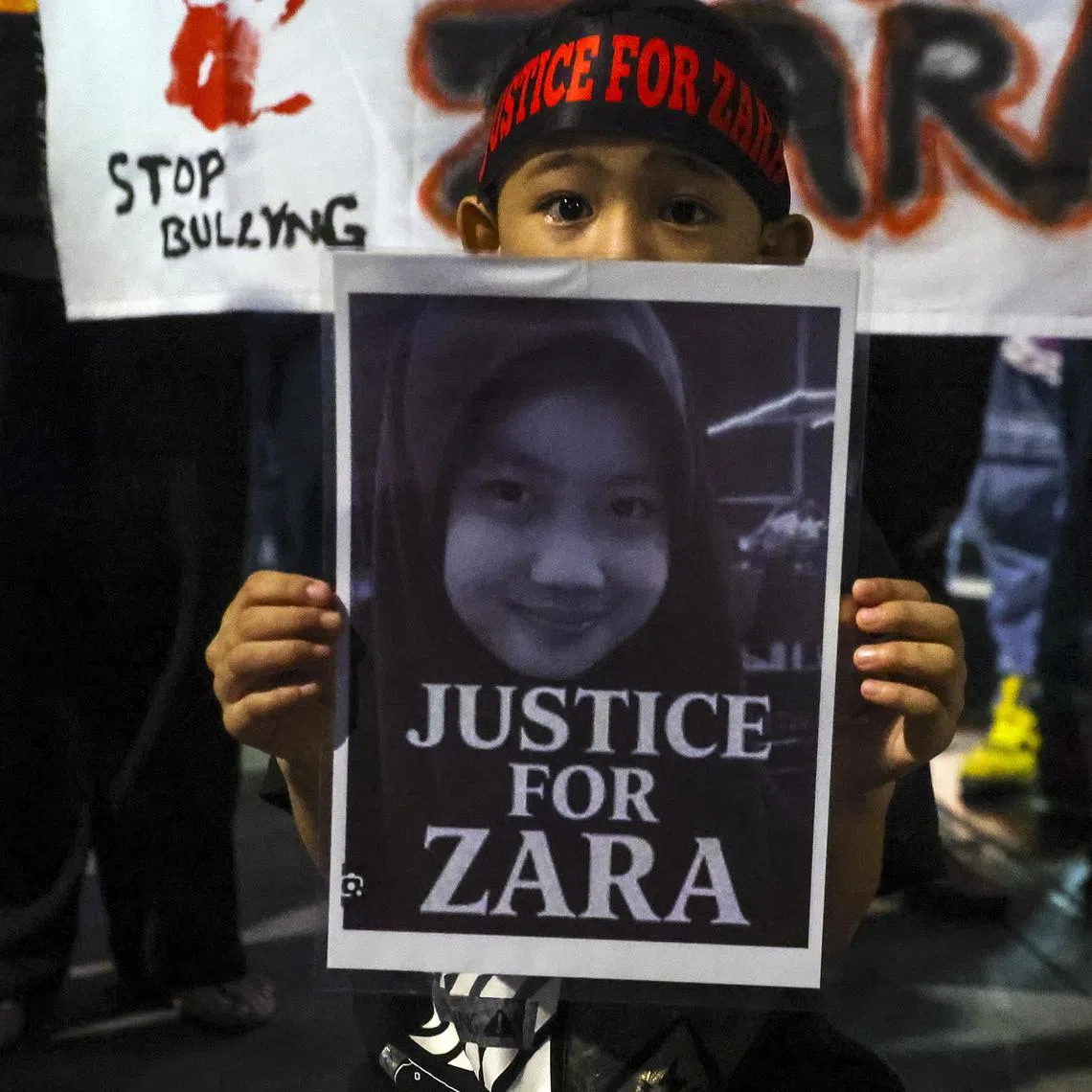 epa12302594 A child holds a placard during a Solidarity for Zara Qairina rally in Kuala Lumpur, Malaysia, 15 August 2025. A 13 years old Zara, from state of Sabah, was found critically injured and unconscious beneath a school dormitory building early on 16 July and died the following day at the hospital. Her death triggered public outcry with allegations of bullying and concern over flaws in the initial investigation surfacing on social media.  EPA/FAZRY ISMAIL