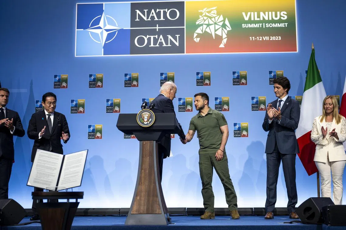 President Joe Biden shakes hands with President Volodymyr Zelensky of Ukraine after a joint declaration of support for Ukraine by the leaders of the Group of Seven nations during the NATO Summit in Vilnius, Lithuania, on Wednesday, July 12, 2023. The alliance added Sweden, laid out new ambitions for itself and offered long-term support for Ukraine, promising membership someday. But Kyiv wanted more. (Doug Mills/The New York Times)