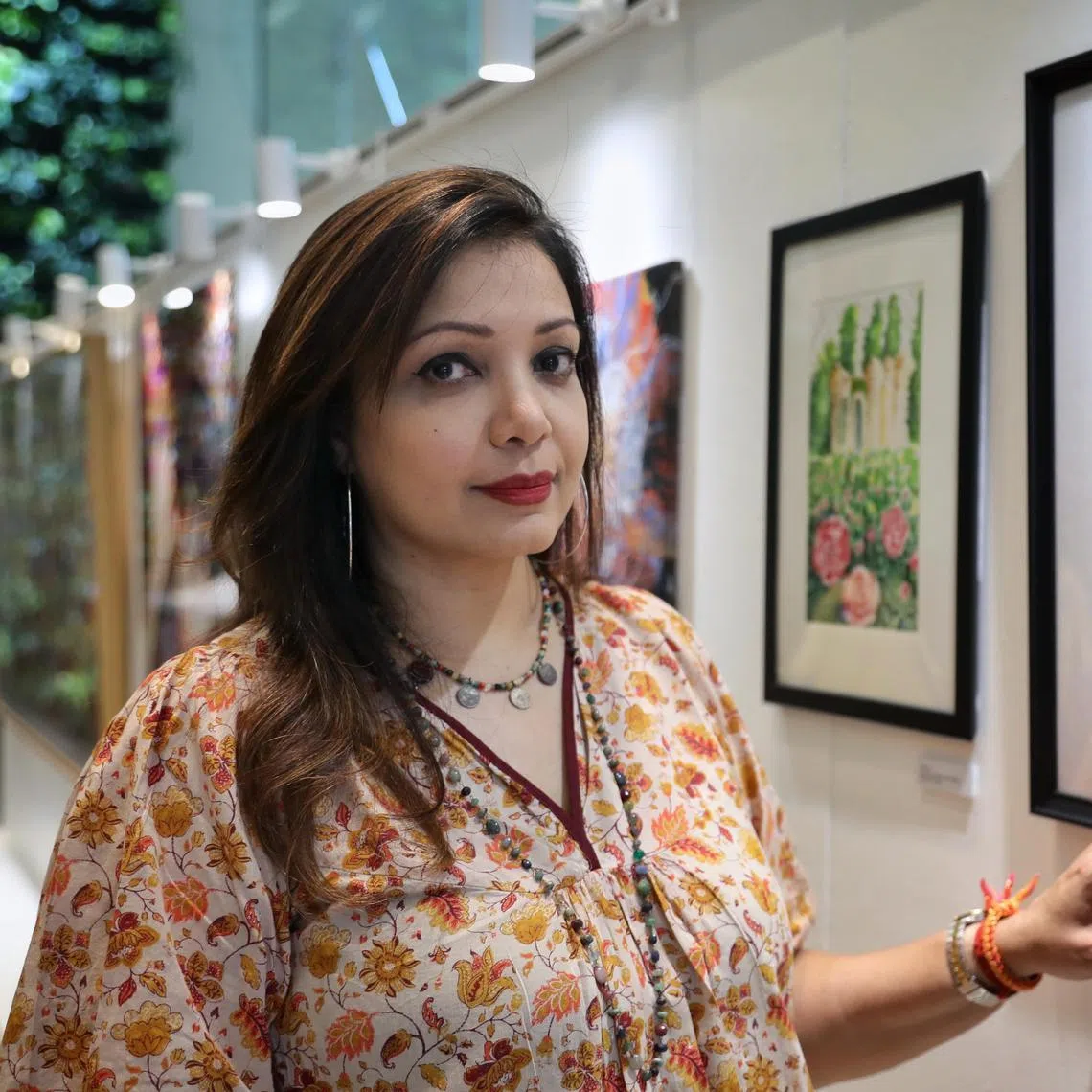 ST20250605_202596000339/jlart05/Taryn Ng/Joyce Lee//

Ms Padmini Naidu, 52, former teacher, and co-owner of IT hardware company , poses beside a watercolour artwork she did under Brahm Centre's art programmes. She was inspired by the colourful nature of Peranakan culture and her love for tile work. She was at the opening of art exhibition 'An Uplifting Journey' on June 5, 2025. The event showcases over 100 heartfelt artworks created by senior participants of Brahm Centre's art programmes. ST PHOTO: TARYN NG