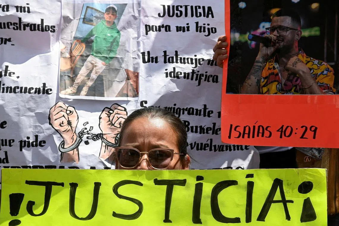 FILE PHOTO: A family member of a Venezuelan migrant, who the U.S. alleged to be a member of the Tren de Aragua gang and sent to the Terrorism Confinement Center (CECOT) prison in El Salvador, holds a sign reading \"Justice\" during a protest in Caracas, Venezuela April 15, 2025. REUTERS/Maxwell Briceno/File Photo