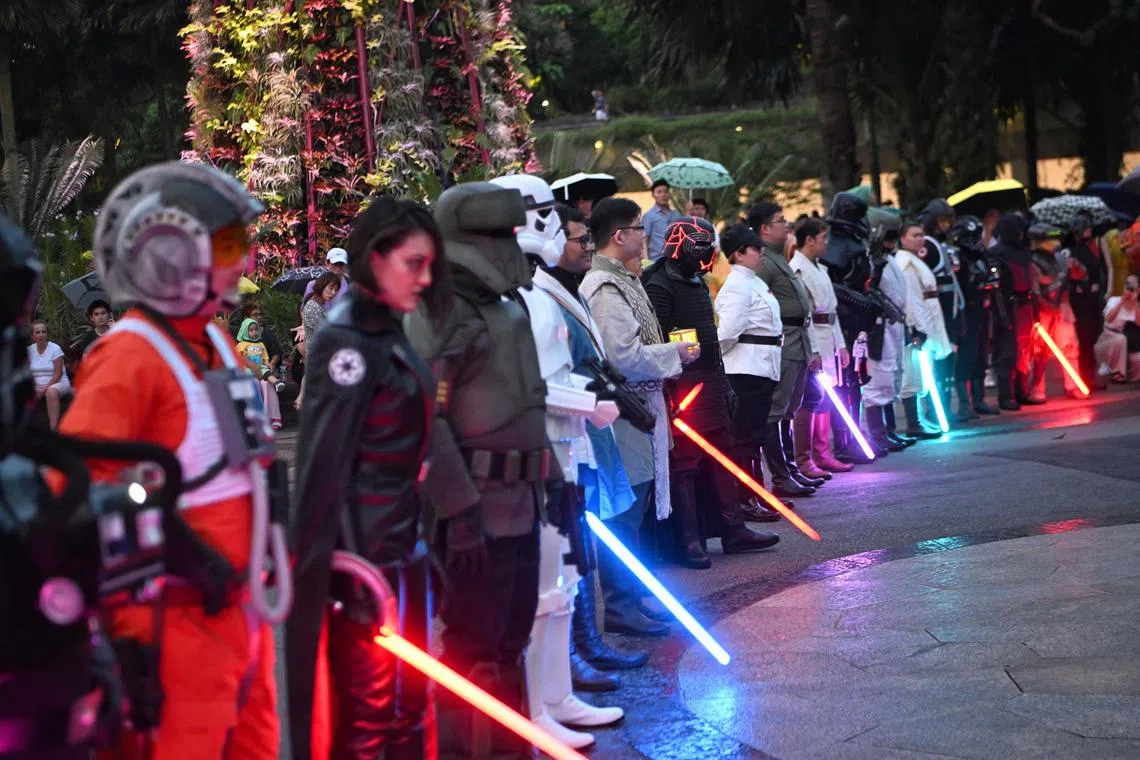 The rain did not stop Star Wars fans from turning out in force at Gardens by the Bay on Thursday, May 4, to celebrate Star Wars Day. More than 20 of them dressed up as various characters from the film franchise, such as Jedi, Sith and stormtroopers, to entertain the crowd as they marched across the Gardens’ Supertree Grove. 
