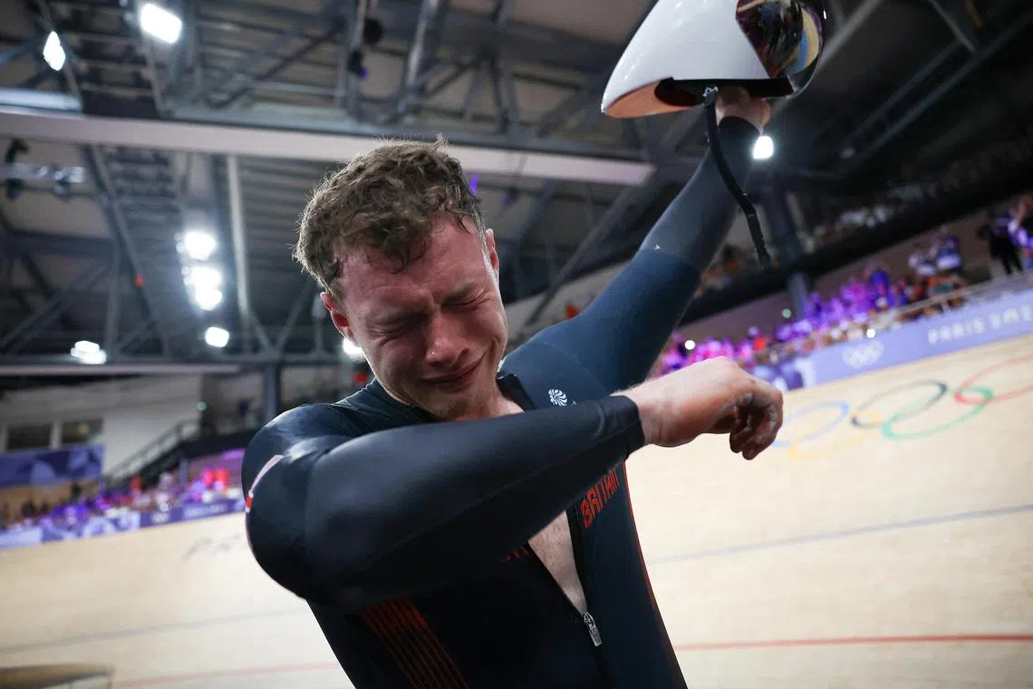 An emotional Jack Carlin of Britain after winning bronze in the Paris Olympics track cycling men's sprint decider at Saint-Quentin-en-Yvelines Velodrome on Aug 9, 2024..