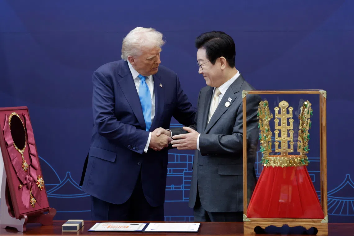 South Korean President Lee Jae Myung with US President Donald Trump on Oct 29. In front of Mr Lee is a replica of a Korean gold crown.