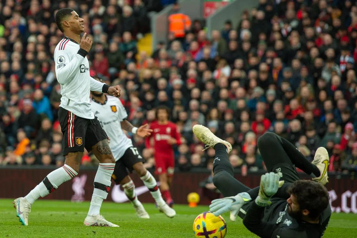 Liverpool goalkeeper Alisson Becker saving a shot from Manchester United's Marcus Rashford at Anfield on Sunday. The Reds won the English Premier League clash 7-0.