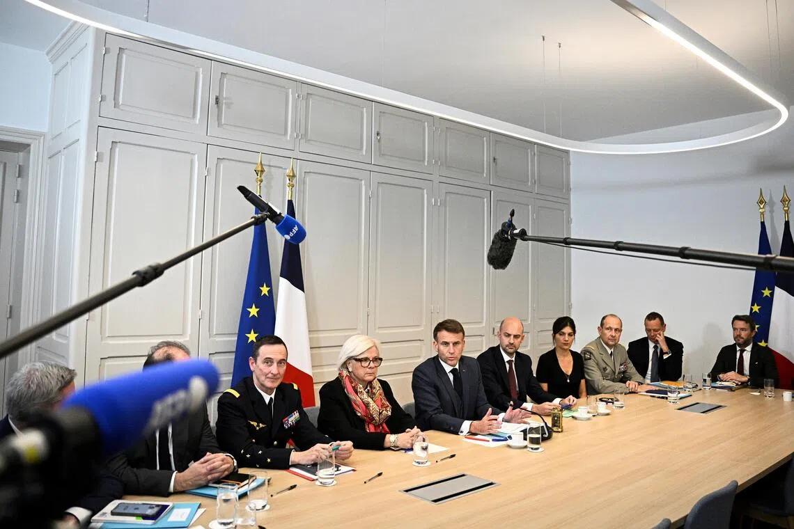 French President Emmanuel Macron (centre) and his team deliver a statement to the press following a virtual meeting of the Coalition of the Willing, in Paris on Nov 25.
