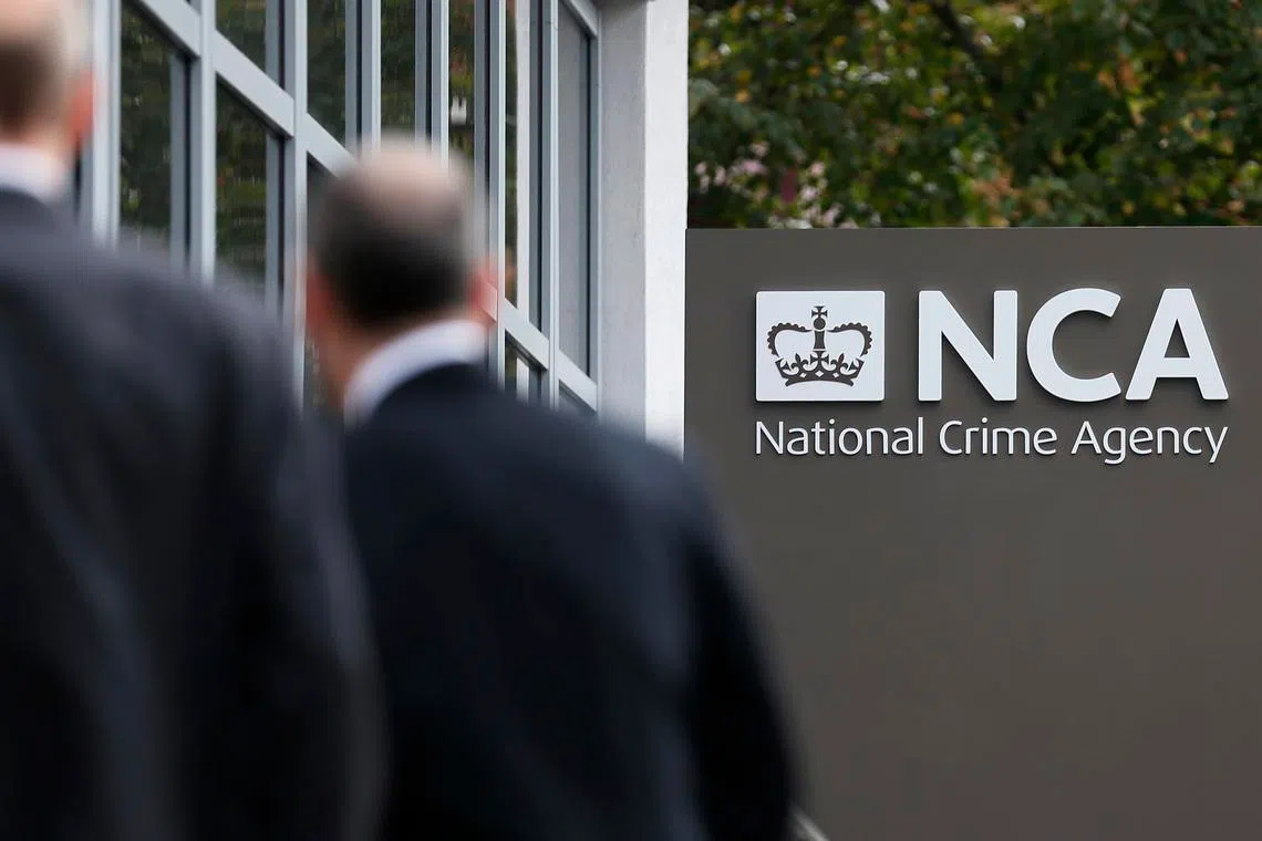 FILE PHOTO: Pedestrians walk past the National Crime Agency (NCA) headquarters in London October 7, 2013. REUTERS/Stefan Wermuth/File Photo