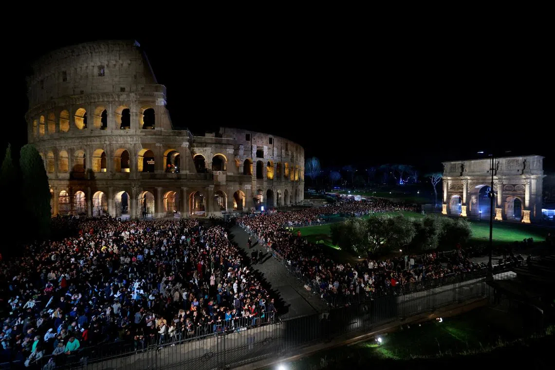 People gather outside the Colosseum, on the day Pope Francis presides over the Via Crucis (Way of the Cross) procession during Good Friday celebrations, in Rome, Italy March 29, 2024. REUTERS/Yara Nardi