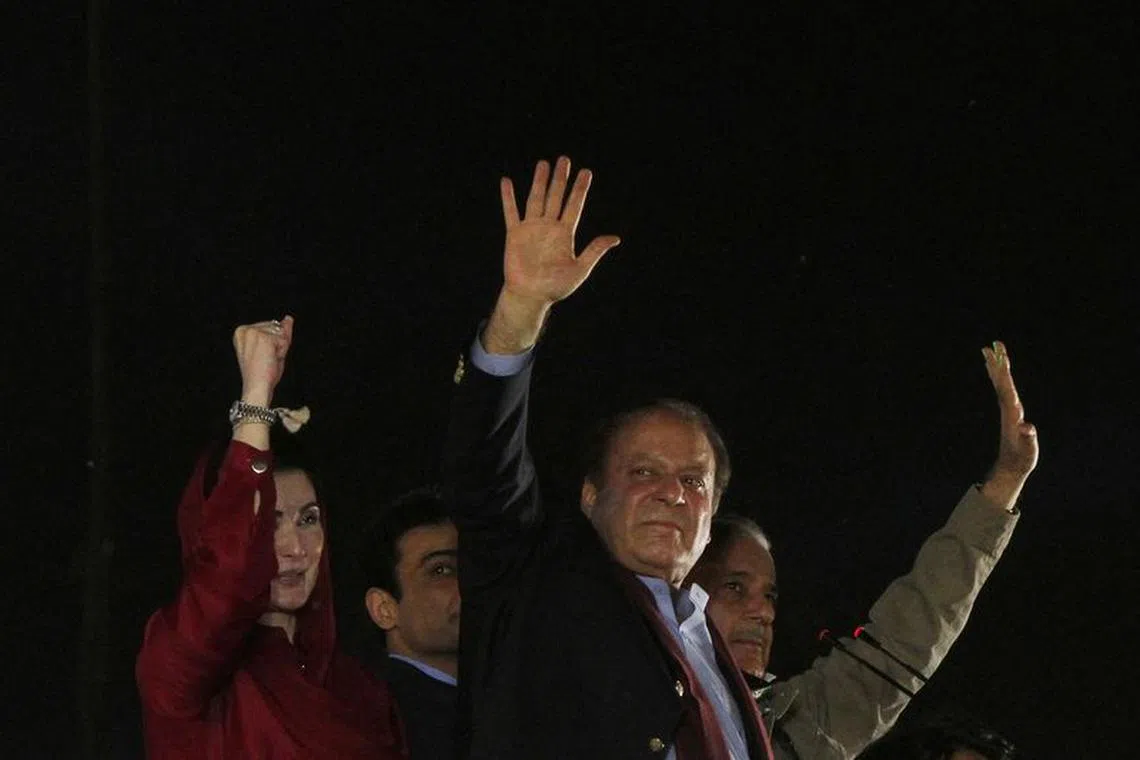 FILE PHOTO: Pakistan's former Prime Minister Nawaz Sharif gestures to supporters upon his arrival from a self-imposed exile in London, ahead of the 2024 Pakistani general election, in Lahore, Pakistan, October 21, 2023. REUTERS/Mohsin Raza/File Photo
