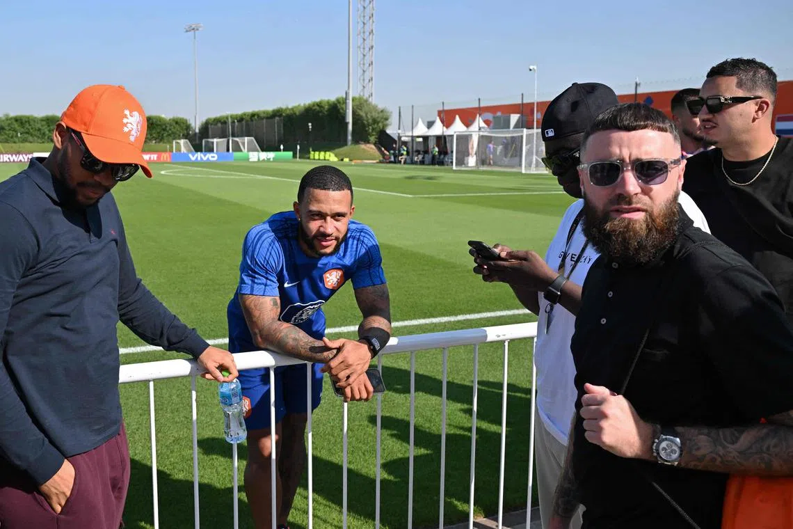 Netherlands forward Memphis Depay chatting with friends after a training session during a media event at the Qatar University in Doha on Saturday. Coach Louis van Gaal says he won't be rushed back into the starting XI. 