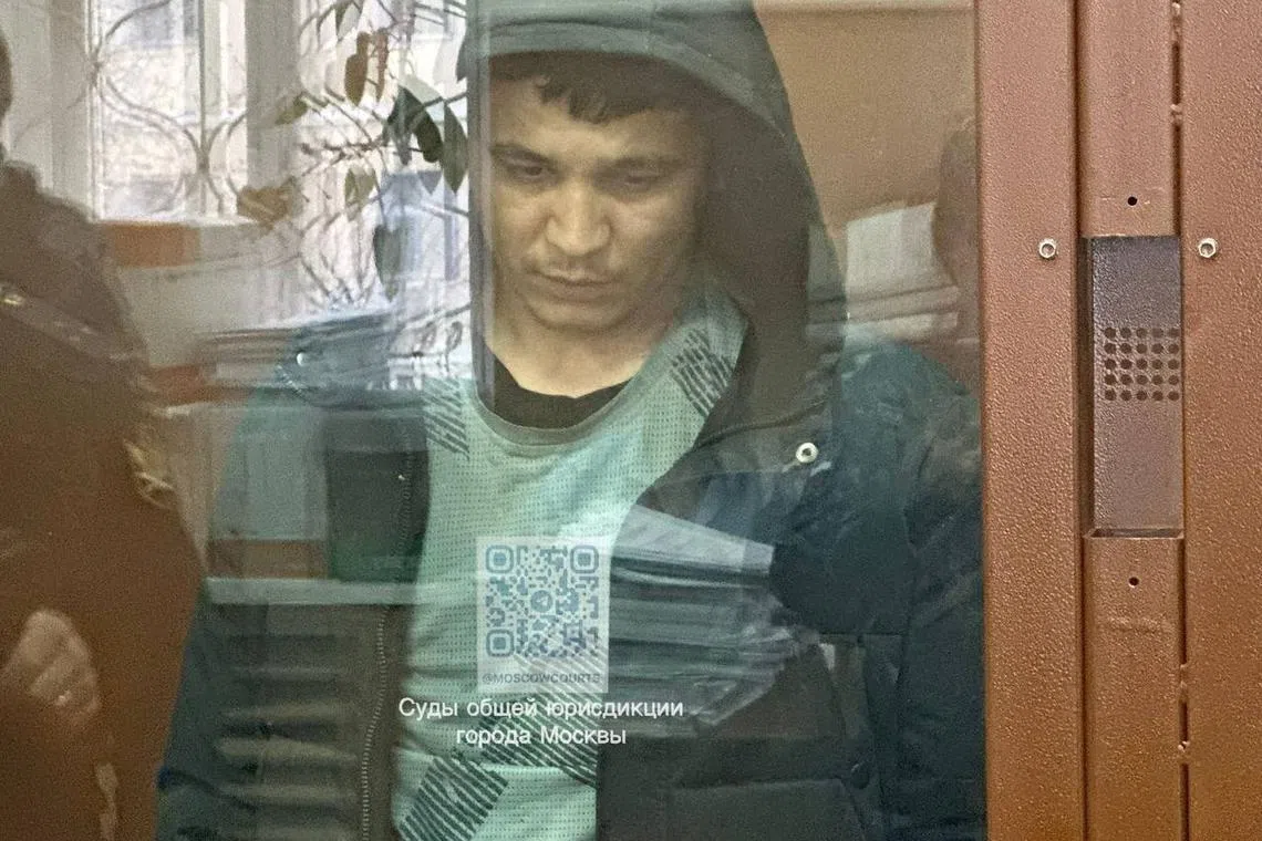 Yakubjoni Yusufzoda, who was arrested in the course of investigation into the Crocus City Hall attack, stands behind a glass wall of an enclosure for defendants in a courtroom in Moscow, Russia April 1, 2024. Moscow City Court's Press Office/Handout via REUTERS